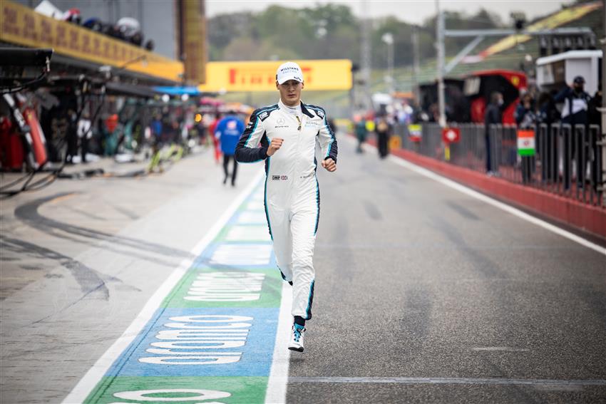 Driver running down pitlane